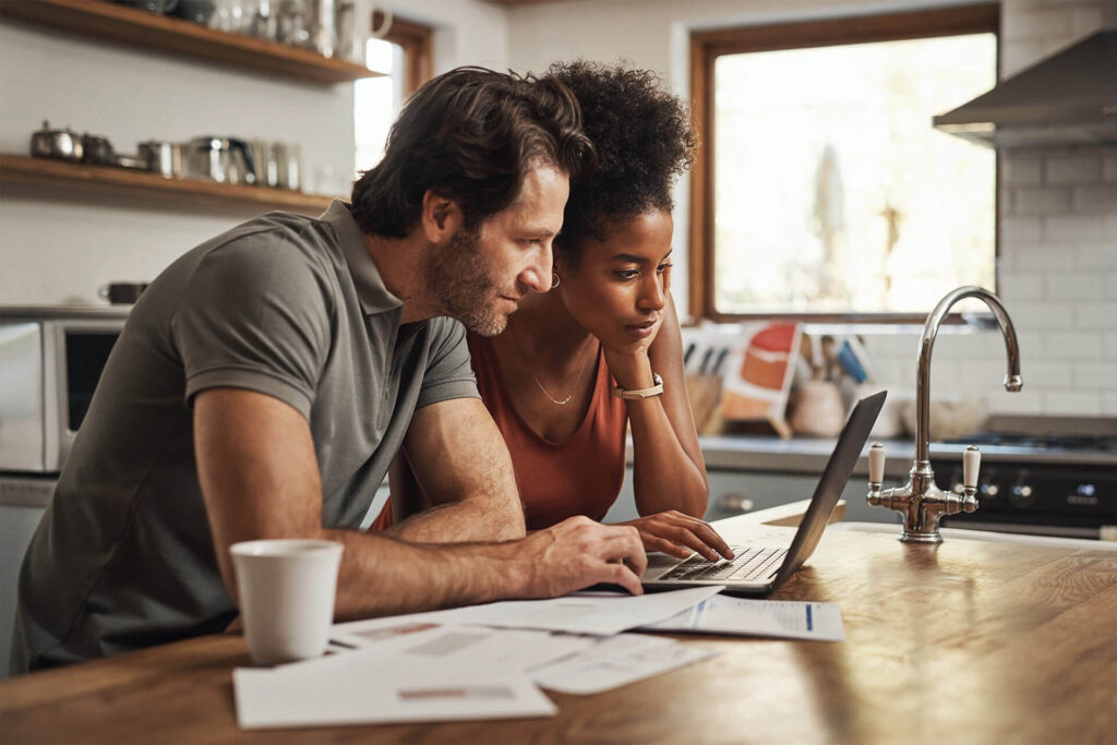 Laptop, couple and financial planning in a kitchen with documents for budget, savings and paying bills.